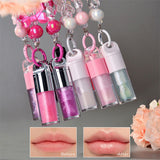 Two-piece Set Of Color-changing Lip Oils And A Bow-shaped Pearl Bracelet Charm.
