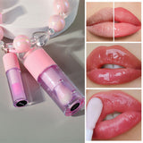 Two-piece Set Of Color-changing Lip Oils And A Bow-shaped Pearl Bracelet Charm.